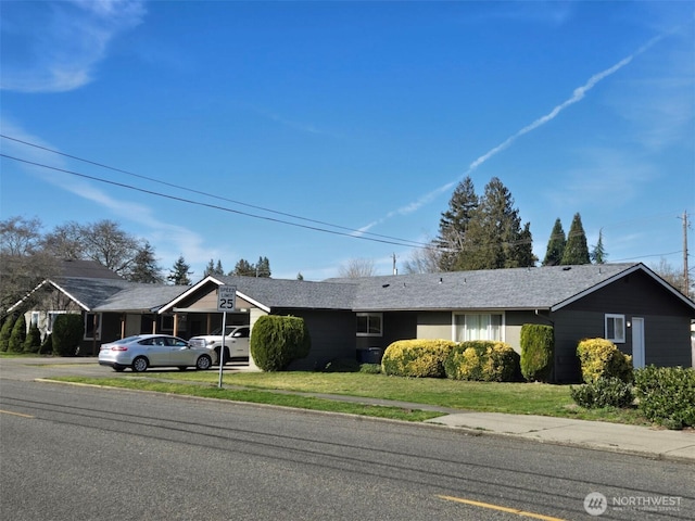 ranch-style home with a front lawn