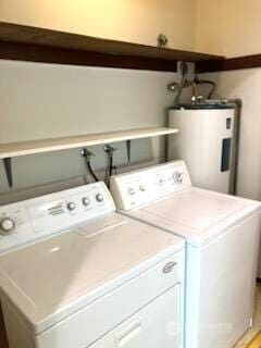 laundry room featuring laundry area, electric water heater, and separate washer and dryer