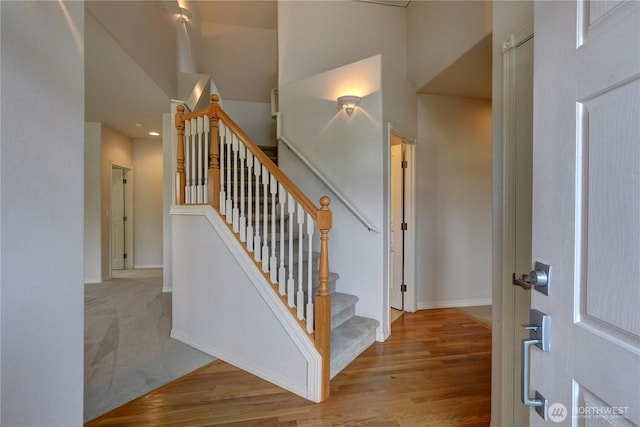 stairway featuring baseboards and wood finished floors