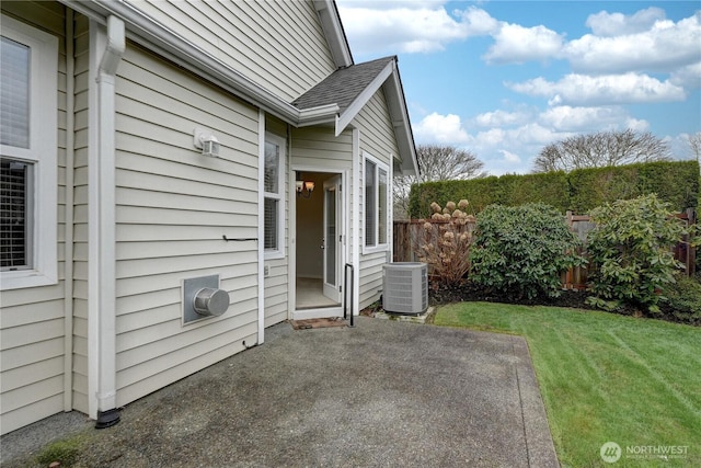 view of patio / terrace featuring central air condition unit and fence