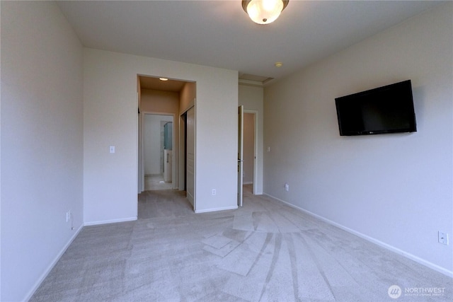 unfurnished bedroom with light carpet and baseboards