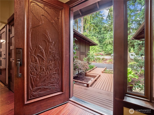 doorway with hardwood / wood-style flooring