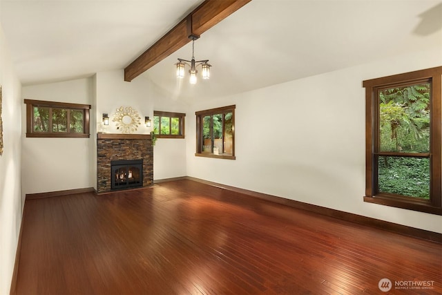 unfurnished living room featuring dark wood-type flooring, a fireplace, lofted ceiling with beams, and baseboards