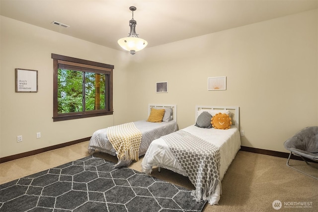 carpeted bedroom with visible vents and baseboards