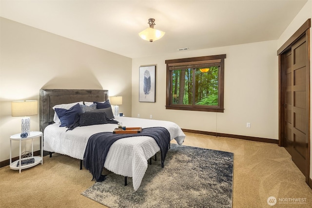 bedroom with light carpet, visible vents, and baseboards