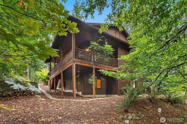 rear view of property featuring board and batten siding