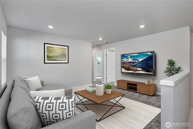 living room featuring baseboards, carpet flooring, and recessed lighting