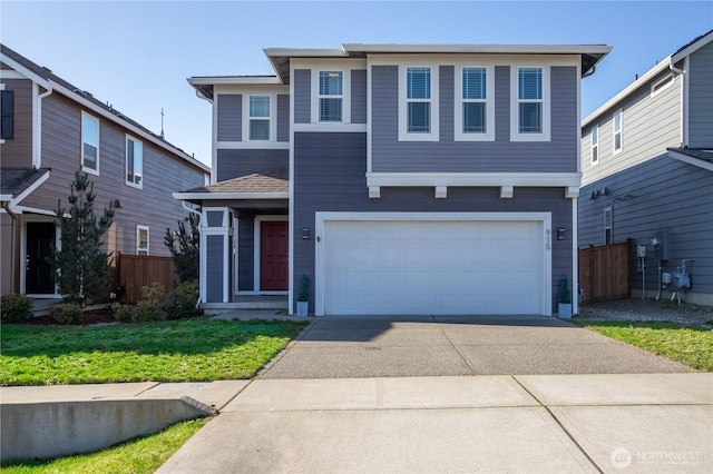 view of front of property with driveway, a garage, fence, and a front yard