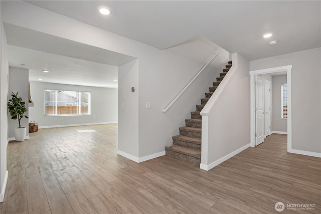 interior space featuring recessed lighting, baseboards, and wood finished floors