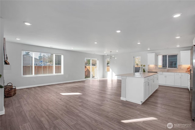 kitchen featuring a wealth of natural light, a kitchen island, and wood finished floors