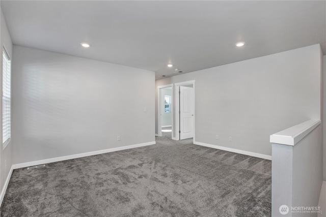 carpeted empty room with baseboards and recessed lighting