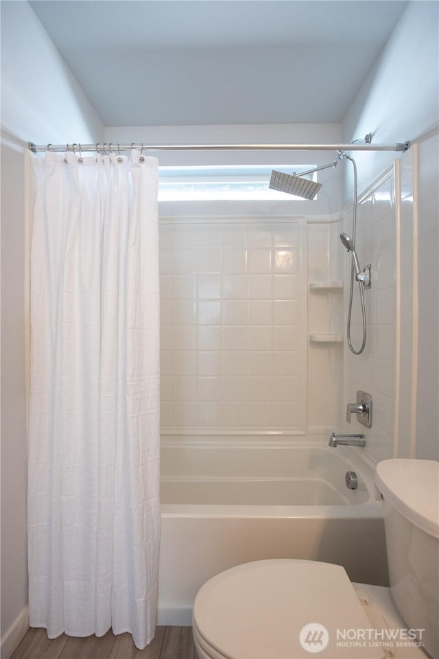 bathroom with toilet and shower / bath combo