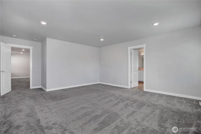 carpeted empty room featuring recessed lighting and baseboards