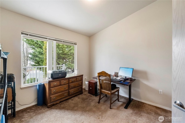 office area featuring carpet flooring, baseboards, and vaulted ceiling