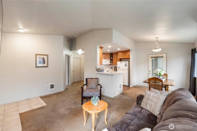 living area with lofted ceiling, light tile patterned floors, baseboards, and light carpet