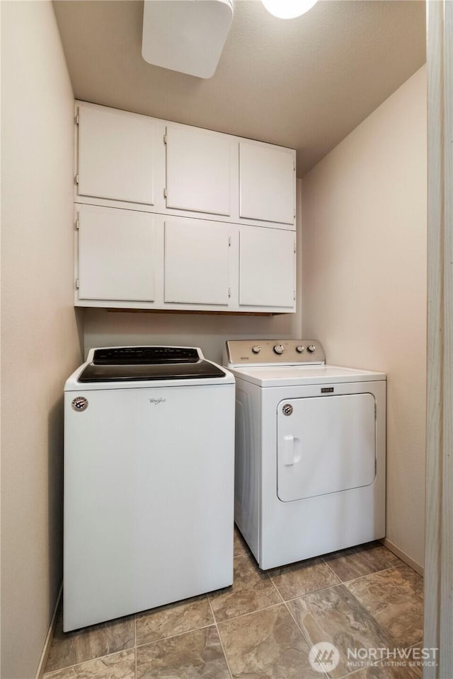 laundry area with washer and clothes dryer, cabinet space, and baseboards