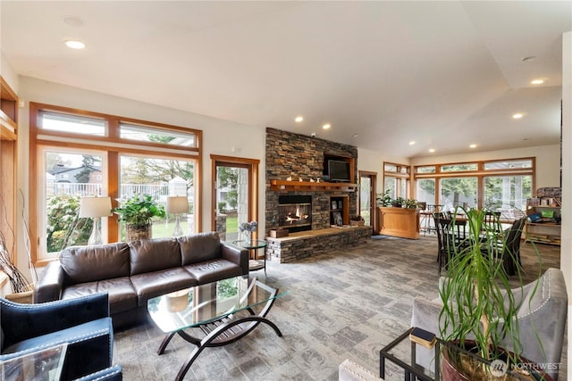 carpeted living area featuring recessed lighting, a fireplace, and vaulted ceiling