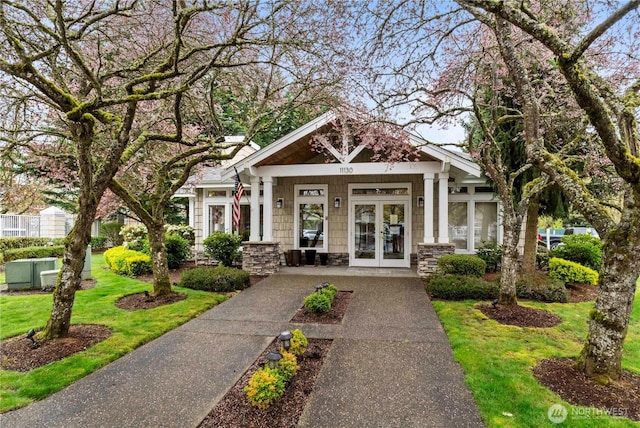 exterior space featuring french doors and a lawn