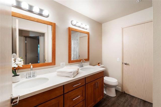 11130 SE 208th St Unit J204, Kent, WA 98031 - bathroom featuring a sink, double vanity, toilet, and wood finished floors