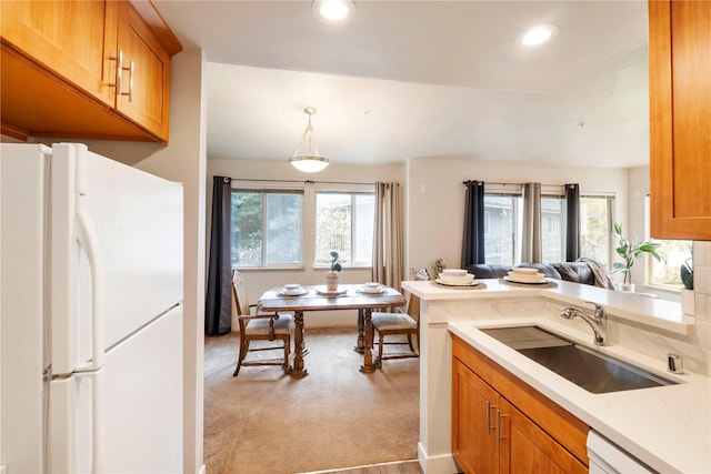 11130 SE 208th St Unit J204, Kent, WA 98031 - kitchen featuring brown cabinetry, white appliances, light colored carpet, light countertops, and a sink