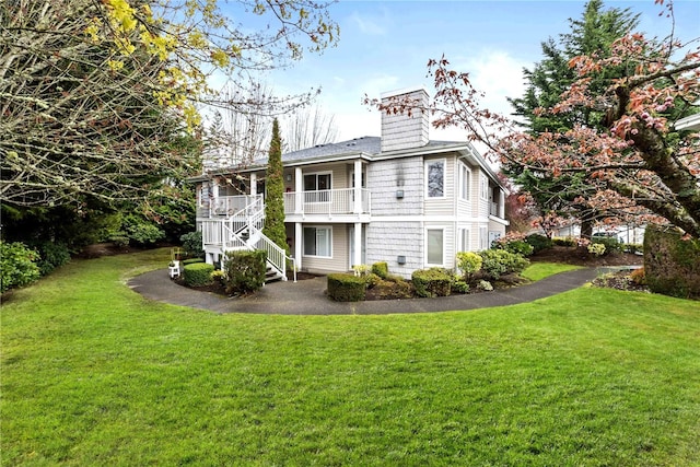 11130 SE 208th St Unit J204, Kent, WA 98031 - back of property featuring a lawn, a chimney, and stairway