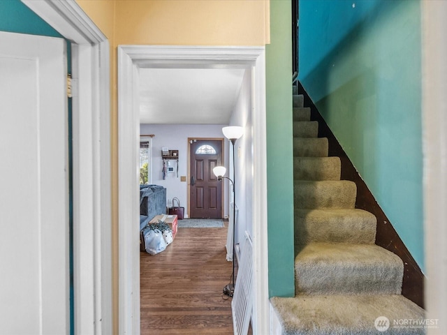 stairway with wood finished floors