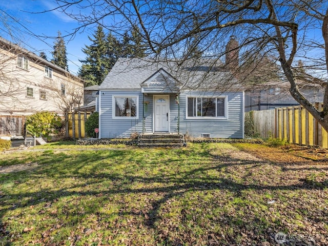 view of front of property with a front lawn and fence