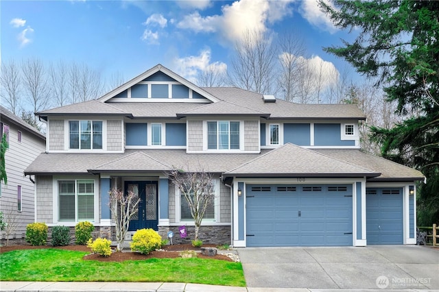 view of front of house with an attached garage, driveway, and a shingled roof