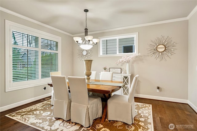 dining space with wood finished floors, baseboards, an inviting chandelier, and ornamental molding