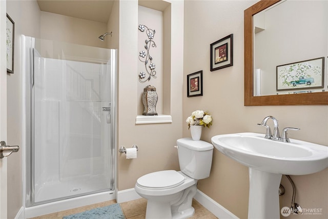 full bath with baseboards, toilet, a stall shower, and tile patterned flooring