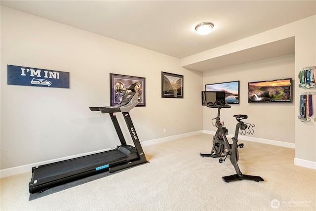 workout area with light colored carpet and baseboards