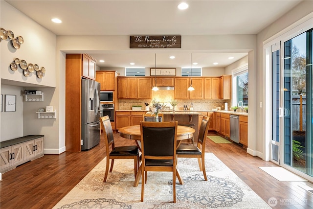 dining area featuring recessed lighting, baseboards, and wood finished floors