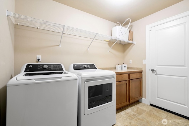 laundry room with cabinet space and separate washer and dryer