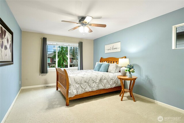 carpeted bedroom featuring a ceiling fan and baseboards