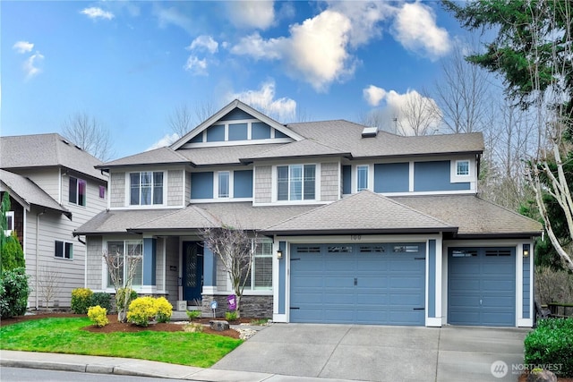 view of front of home featuring a garage, roof with shingles, and concrete driveway