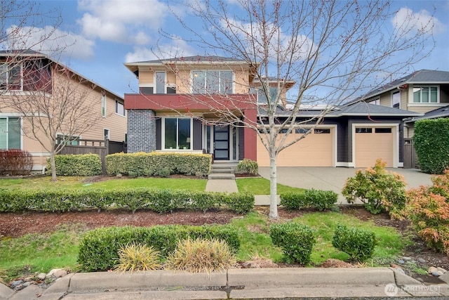 view of front of property featuring fence, a garage, and driveway