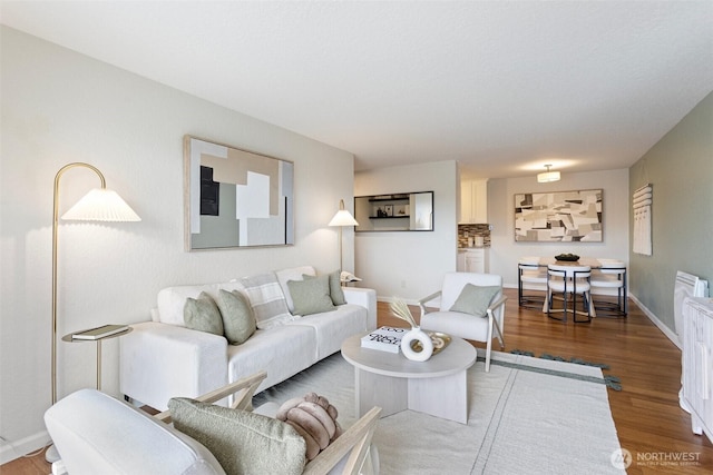 living room with wood finished floors and baseboards