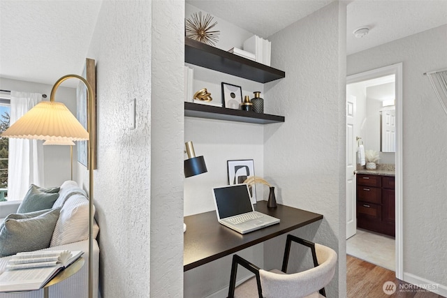 office space featuring a textured wall and wood finished floors