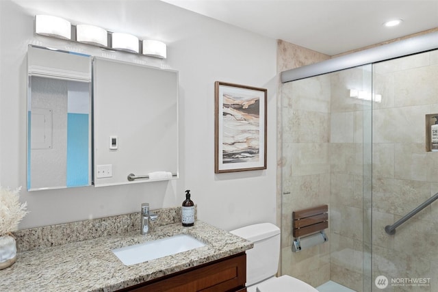 full bath featuring toilet, a shower stall, vanity, and recessed lighting