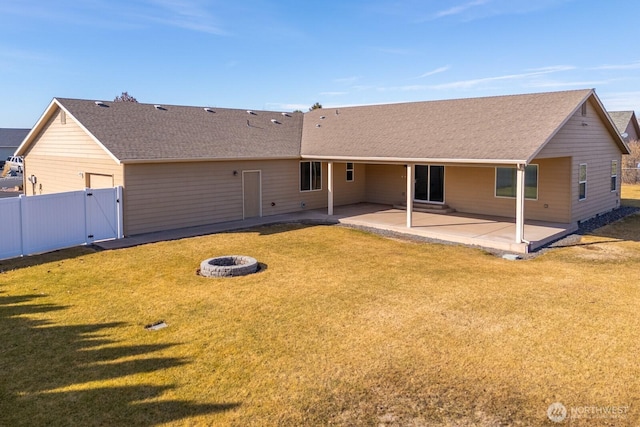 back of house featuring an outdoor fire pit, a gate, fence, a yard, and a patio area