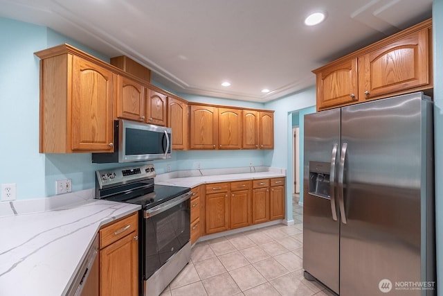 kitchen with light tile patterned floors, stainless steel appliances, brown cabinetry, and recessed lighting