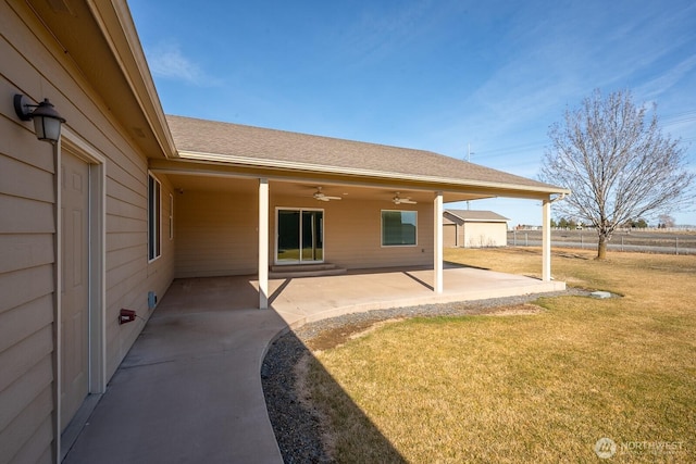 exterior space with ceiling fan and fence