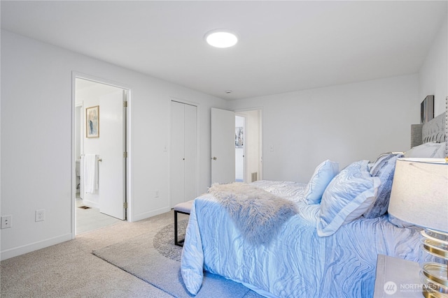 bedroom featuring carpet floors, ensuite bath, and baseboards