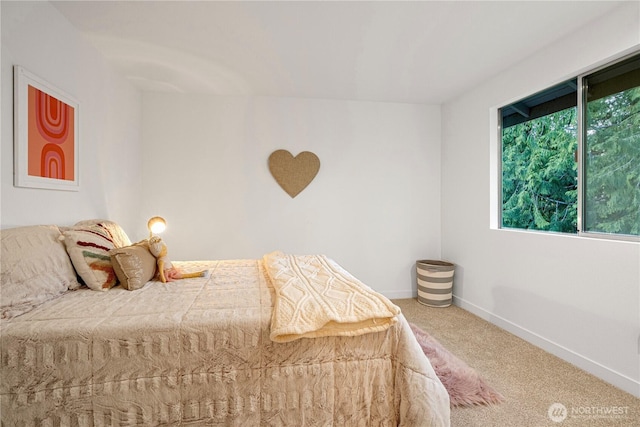 bedroom featuring baseboards and carpet flooring