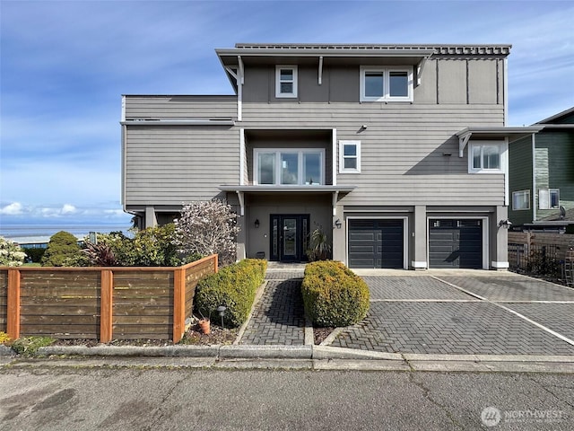 view of front of house with driveway, fence, and an attached garage