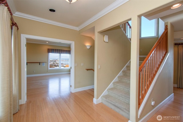 staircase with crown molding, wood finished floors, baseboards, and recessed lighting