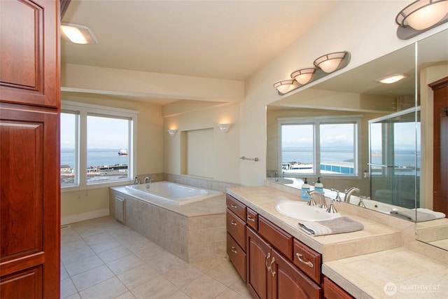 bathroom with tile patterned floors, vanity, a garden tub, and a stall shower