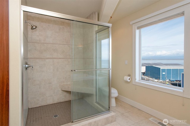 full bath featuring a shower stall, tile patterned flooring, visible vents, and toilet