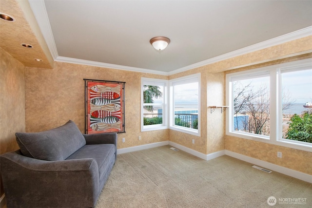 sitting room with crown molding, visible vents, baseboards, and carpet