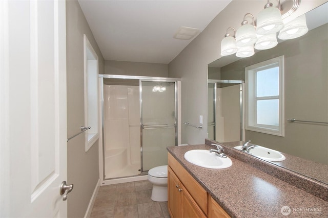 full bath with toilet, a stall shower, vanity, and tile patterned flooring